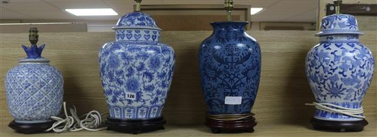 A set of four blue and white table lamp bases